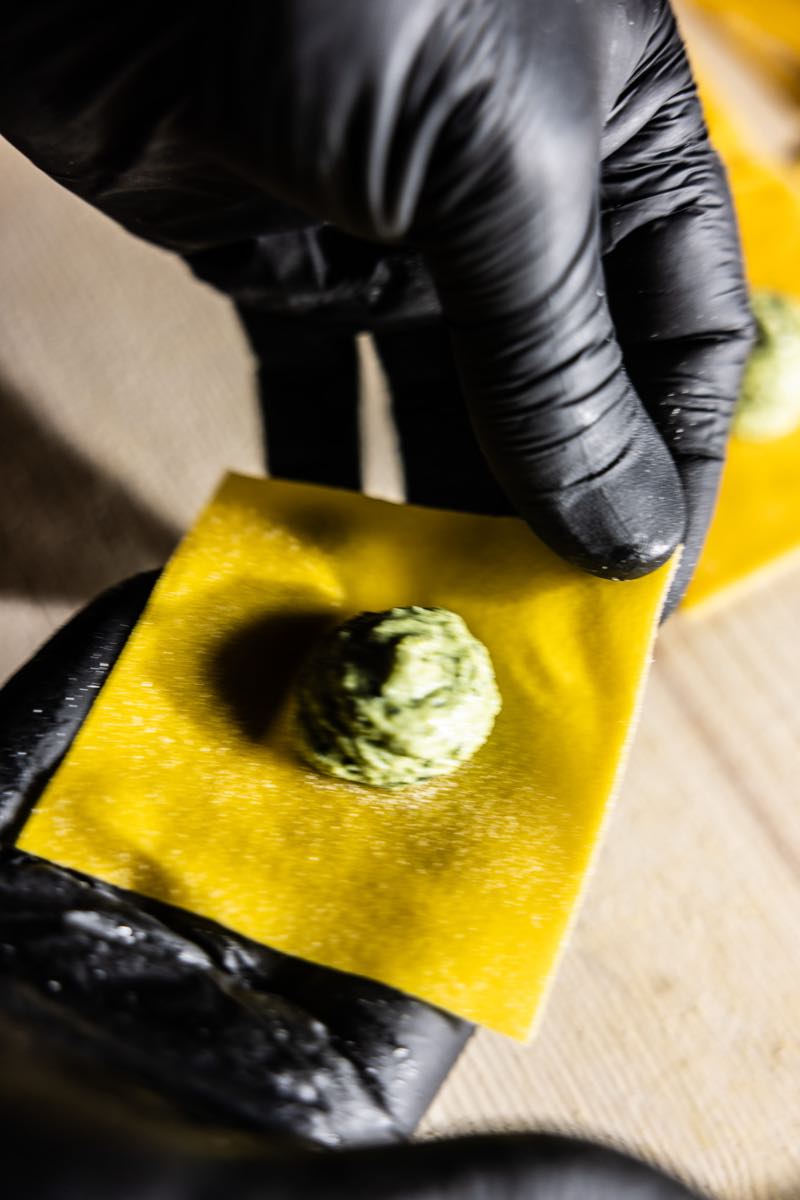 Chef's hands shaping fresh filled pasta at Rimessa Roscioli